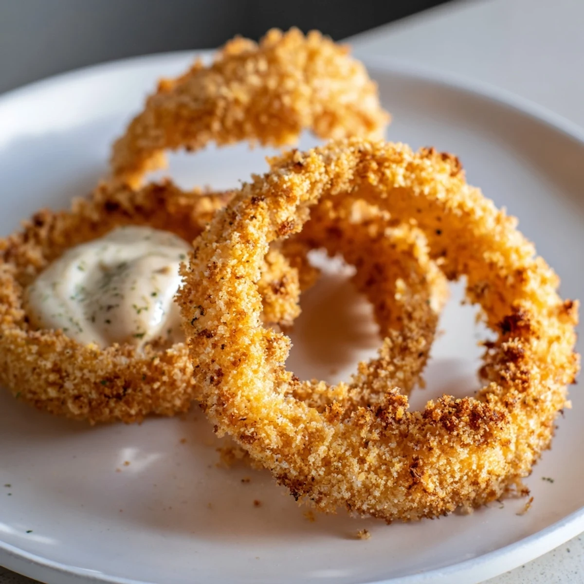 Freshly cooked Air Fryer Onion Rings with Chipotle Mayo, served hot as a tasty snack.