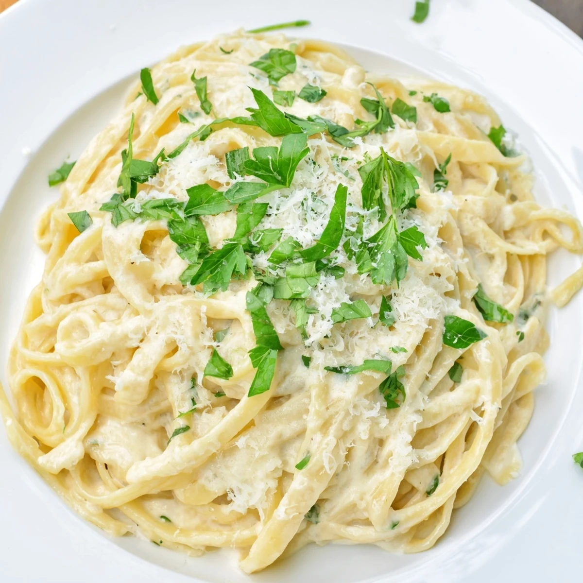 Serving Creamy Garlic Pasta with Herbs alongside garlic bread, a glass of white wine on a rustic table.
