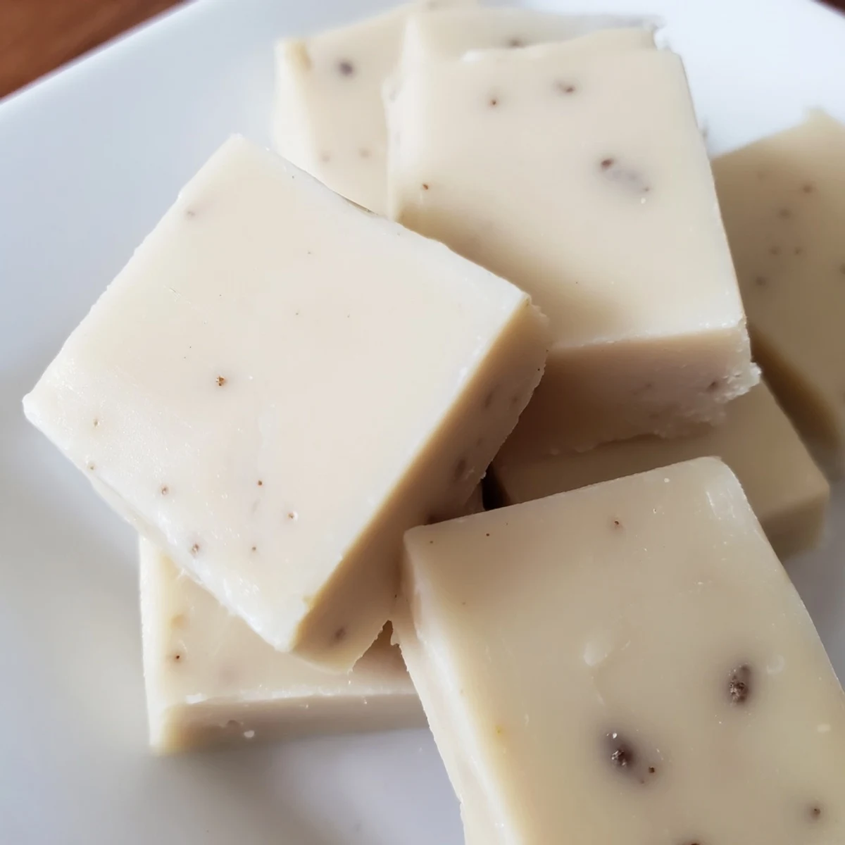 Close-up of homemade Irish Cream Fudge squares, cut cleanly and ready to serve on a platter for a holiday party.