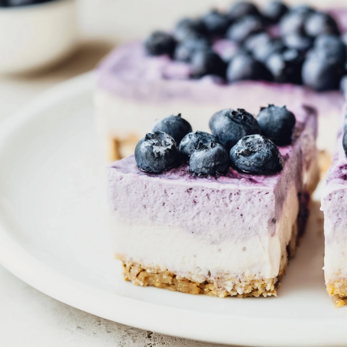A slice of Blueberry Mousse Cheesecake with a creamy texture and fresh berry garnish.