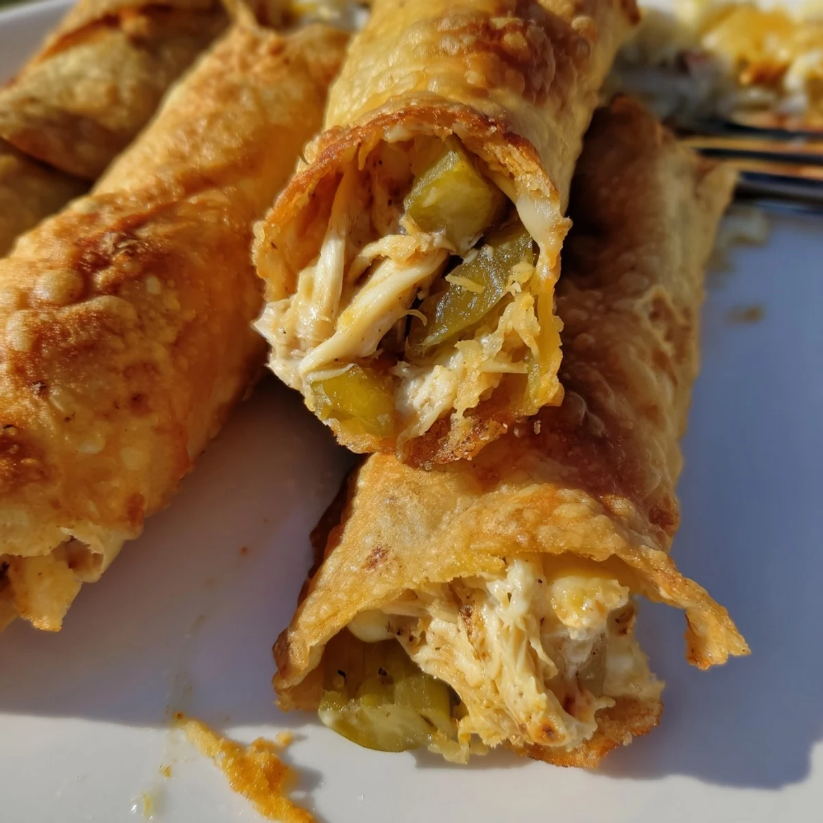 Golden-brown Dill Pickle Ranch Chicken Taquitos, baked until crispy and served with a side of extra ranch for dipping.