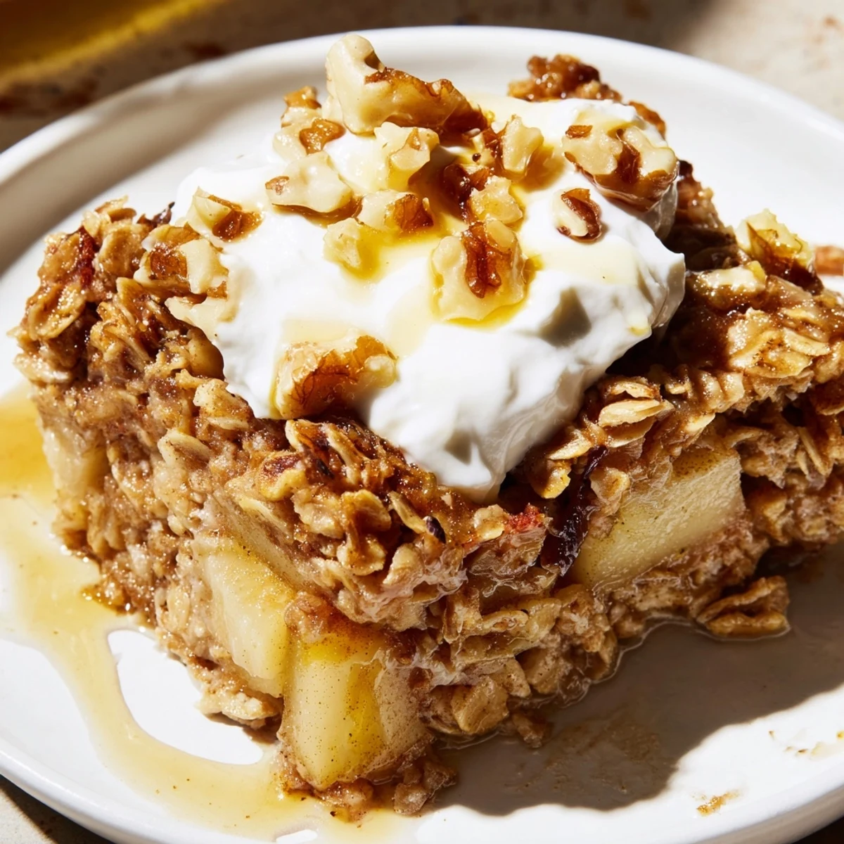 Warm Baked Apple Oatmeal With Greek Yogurt topped with cinnamon-kissed apples and a creamy dollop.  