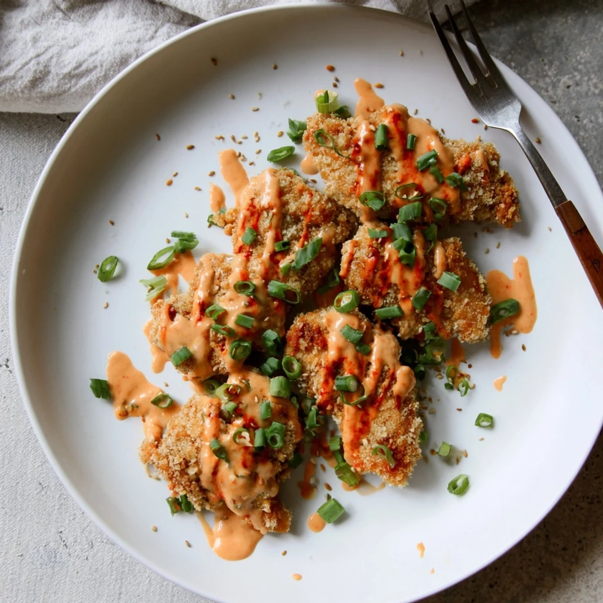 Quick Low Carb Bang Bang Chicken served hot with toasted sesame seeds and fresh scallions, perfect over cauliflower rice or in lettuce cups.