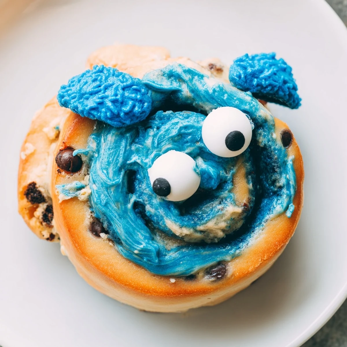 Homemade American-style Cookie Monster Cinnamon Rolls on a baking dish, ready to serve for a fun breakfast or dessert.