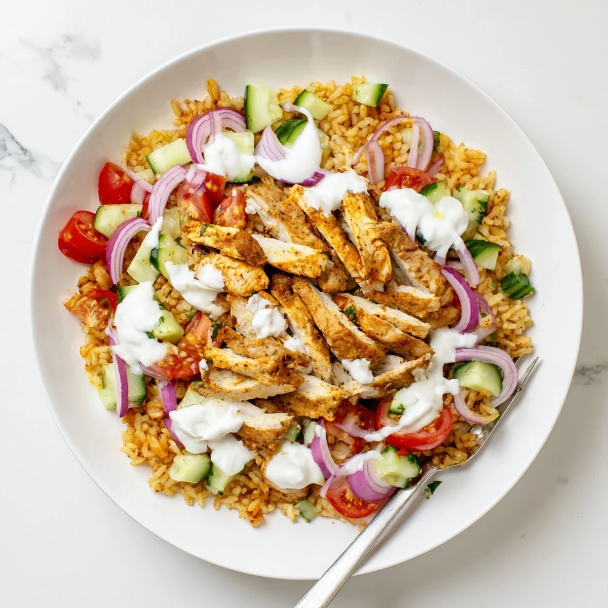 Golden spiced chicken shawarma Salad with crispy rice and fresh vegetables drizzled with tangy yogurt