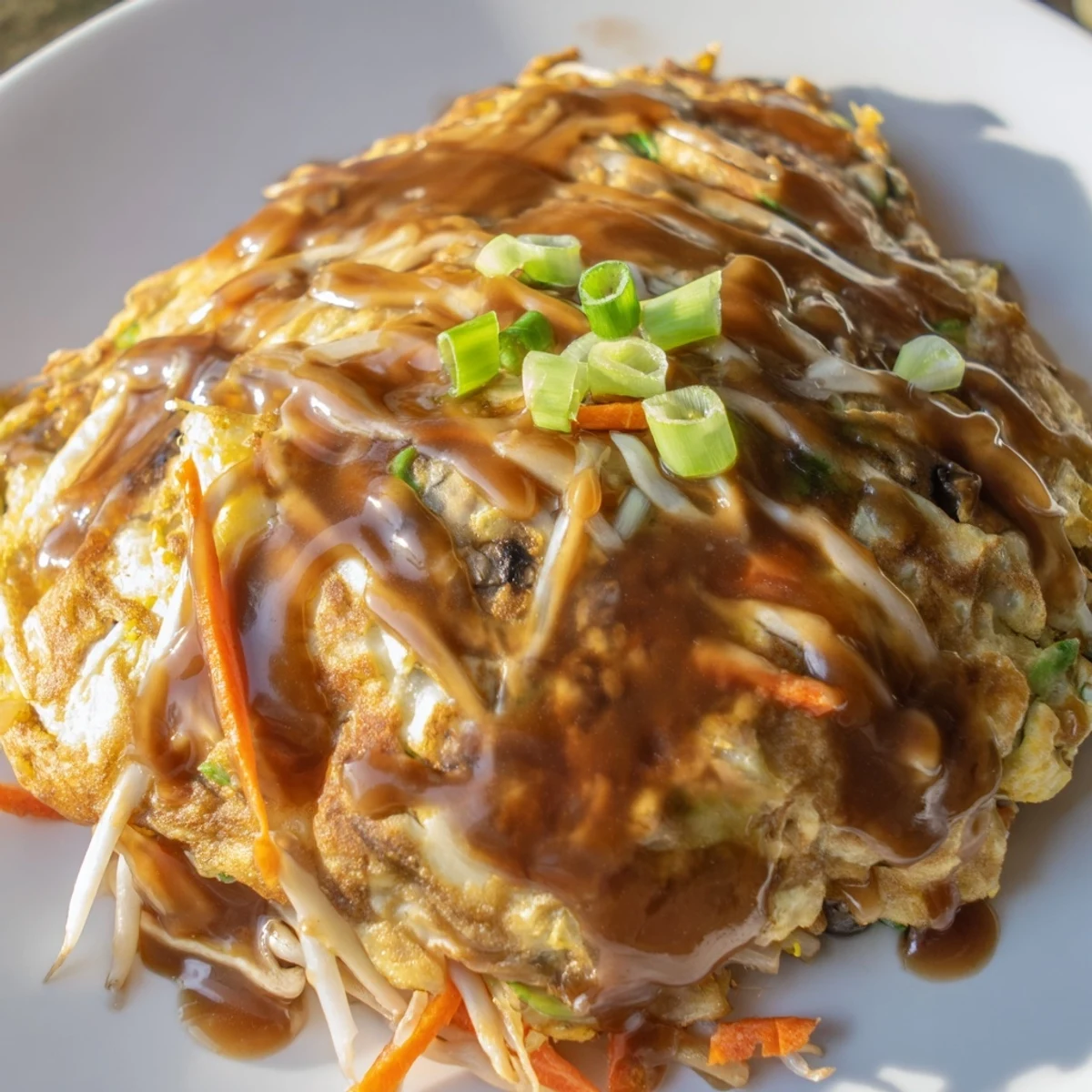 Chinese-American Egg Foo Young served hot with bean sprouts and smooth brown gravy sauce