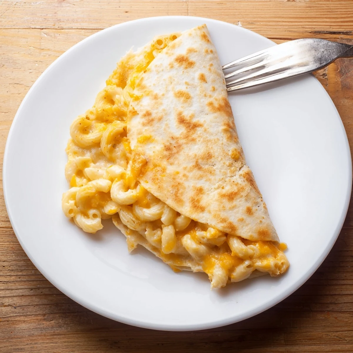 Golden brown mac and cheese quesadillas sliced into wedges revealing creamy cheesy pasta filling