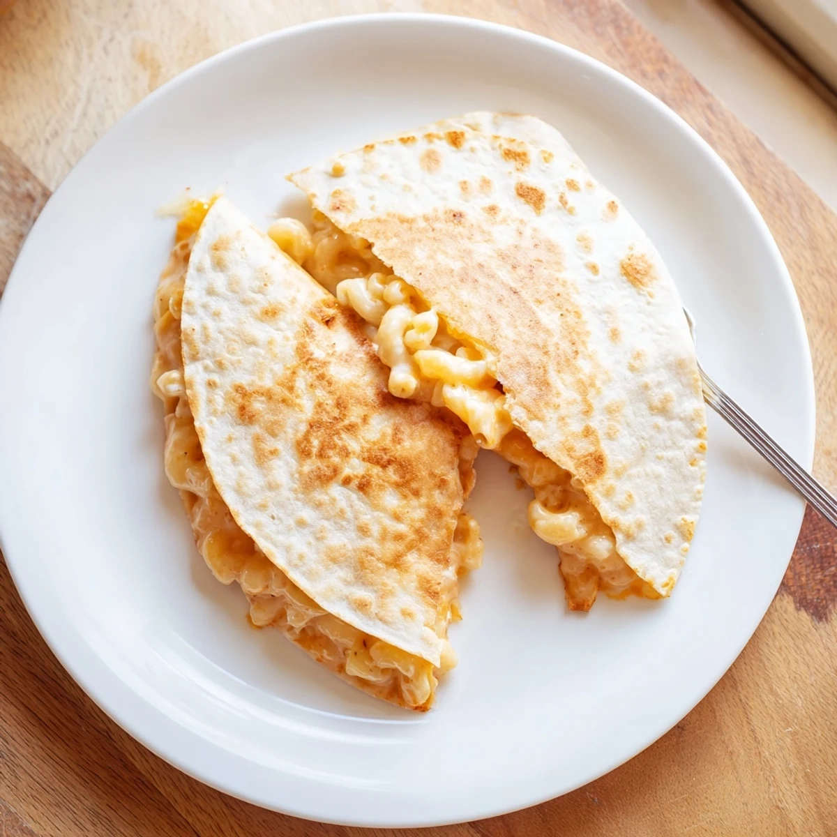 American-Mexican fusion quesadilla with golden tortilla edges and oozing melted cheese sauce center
