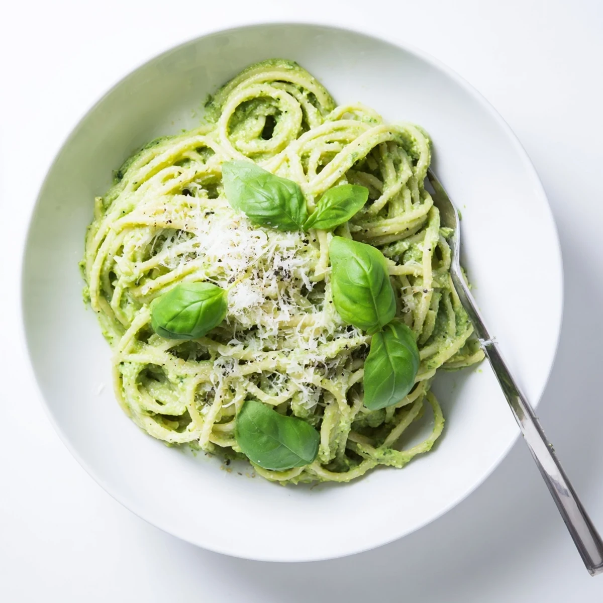 Al dente spaghetti tossed with rich avocado pesto featuring fresh spinach and aromatic basil