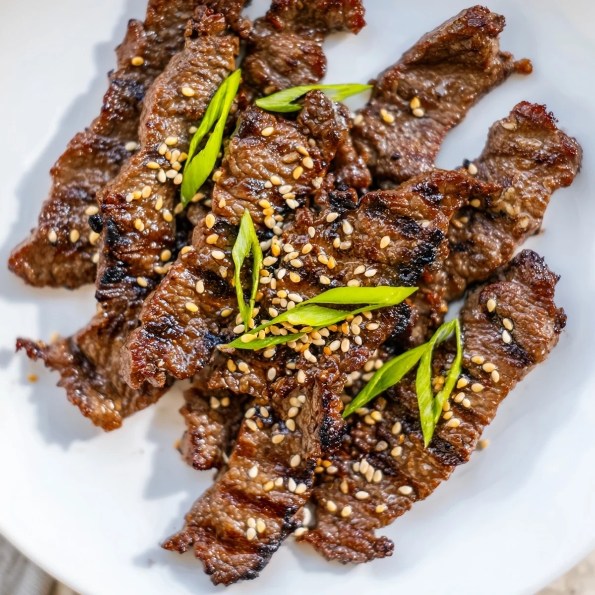 Flanken cut beef short ribs grilled Korean-style with caramelized glaze and toasted sesame topping