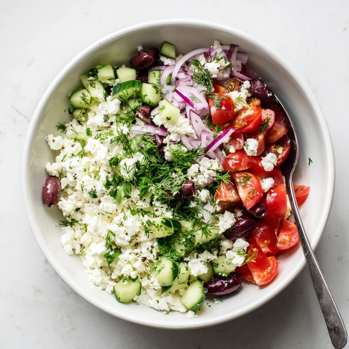 Protein-packed Greek salad cottage cheese bowl featuring crisp veggies and Mediterranean herbs