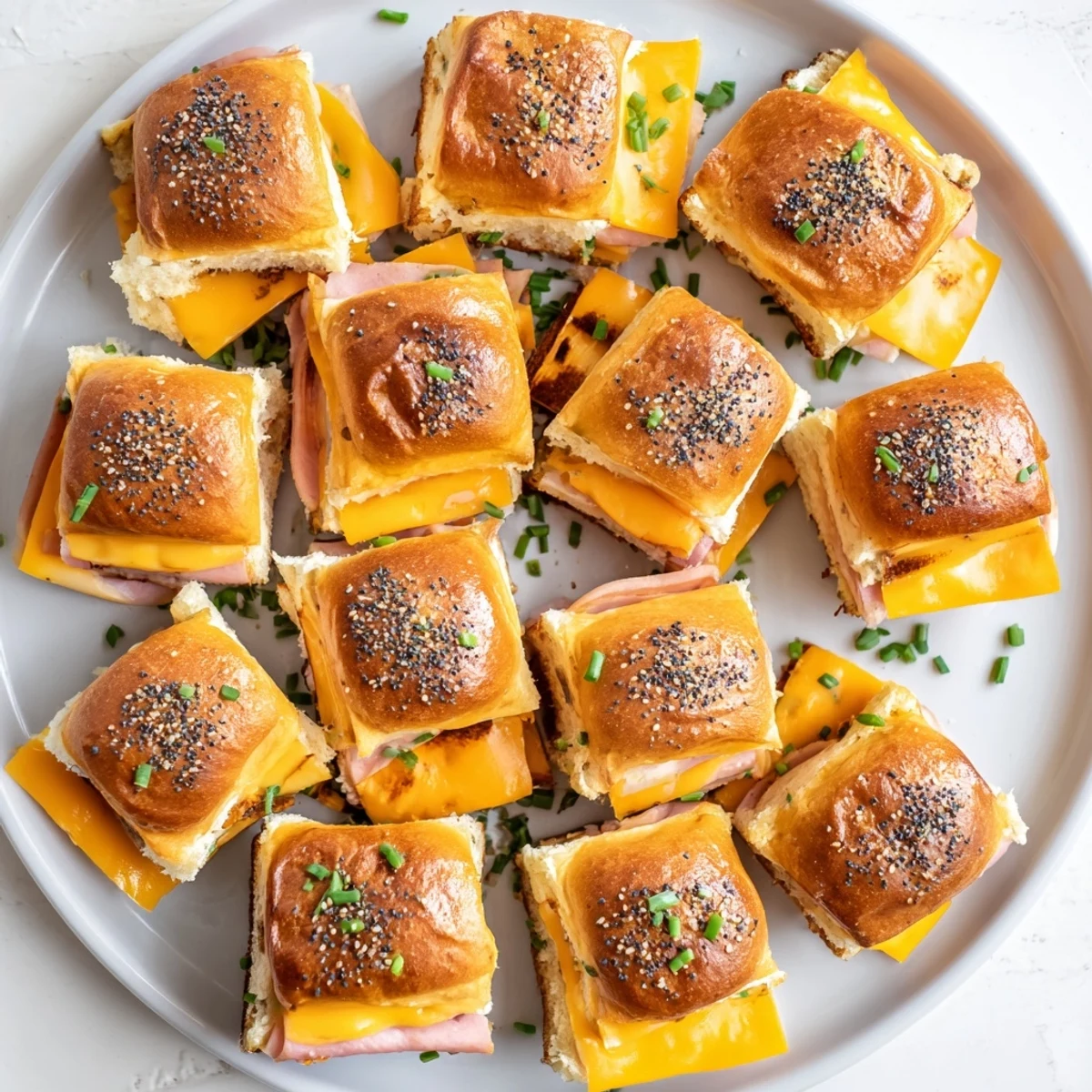 Golden sweet and savory mini grilled cheese Hawaiian rolls with melted cheddar cheese and honey mustard glaze