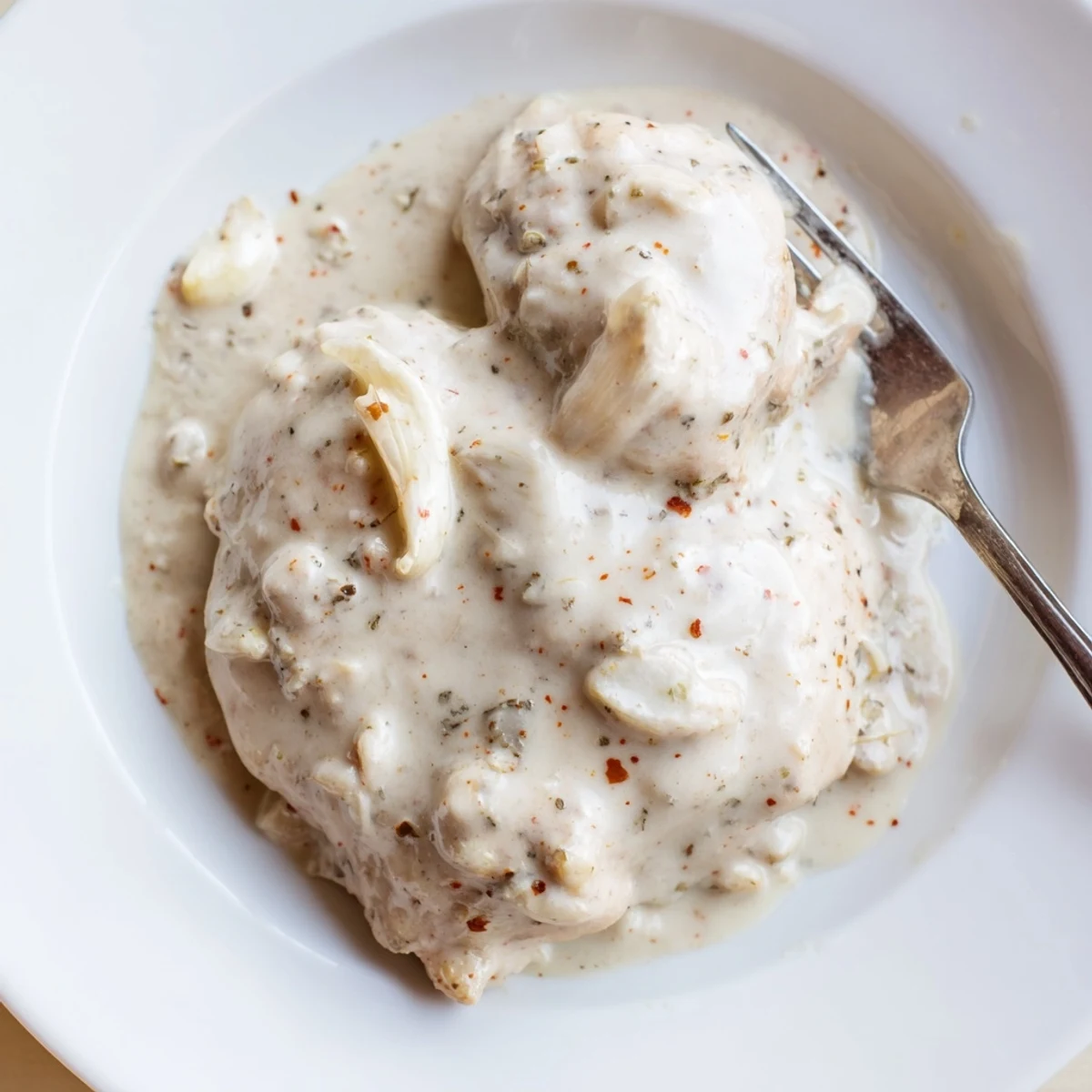 Tender slow cooker chicken thighs coated in thick creamy gravy with Italian herbs.
