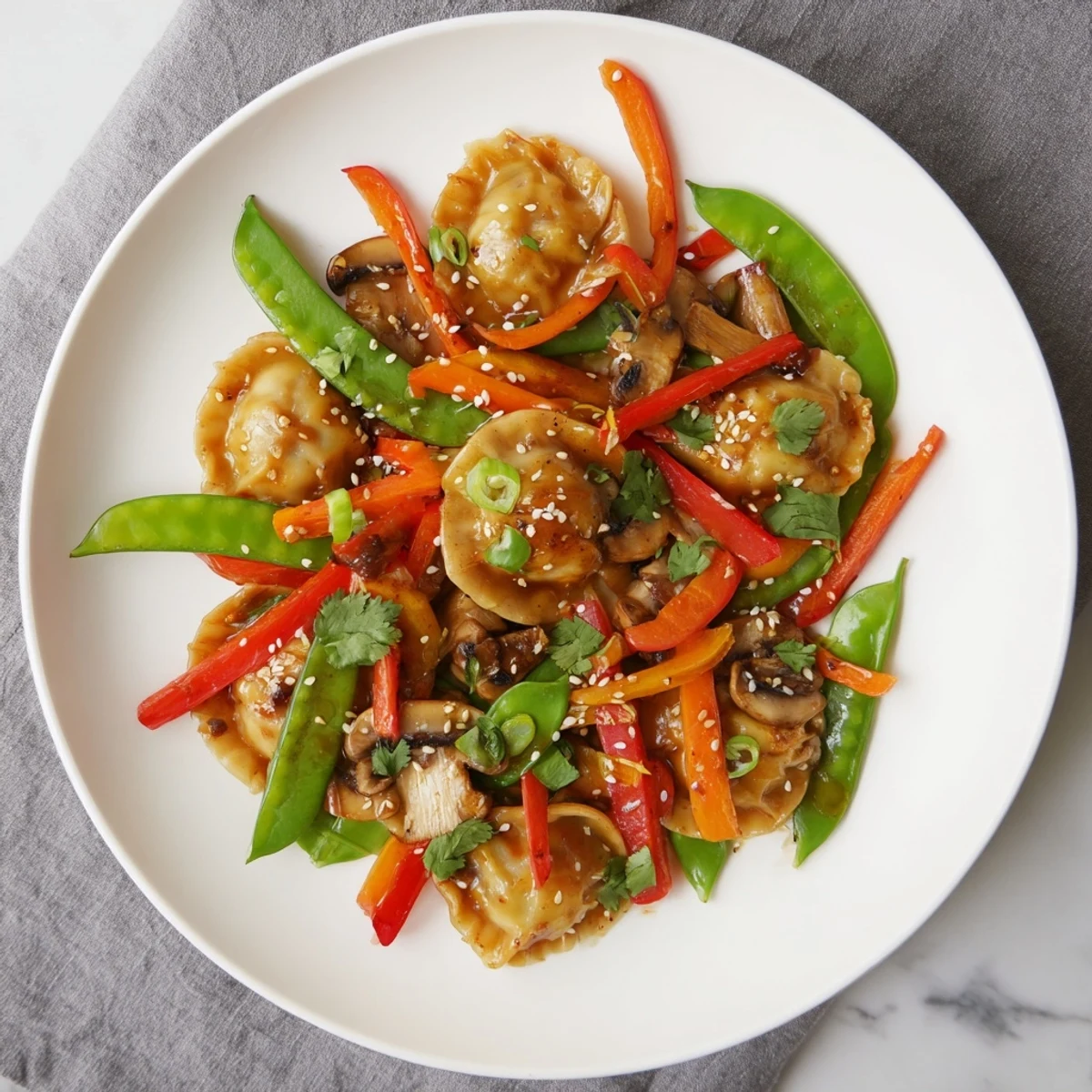 Golden crispy potsticker stir fry with colorful vegetables in savory soy sesame sauce