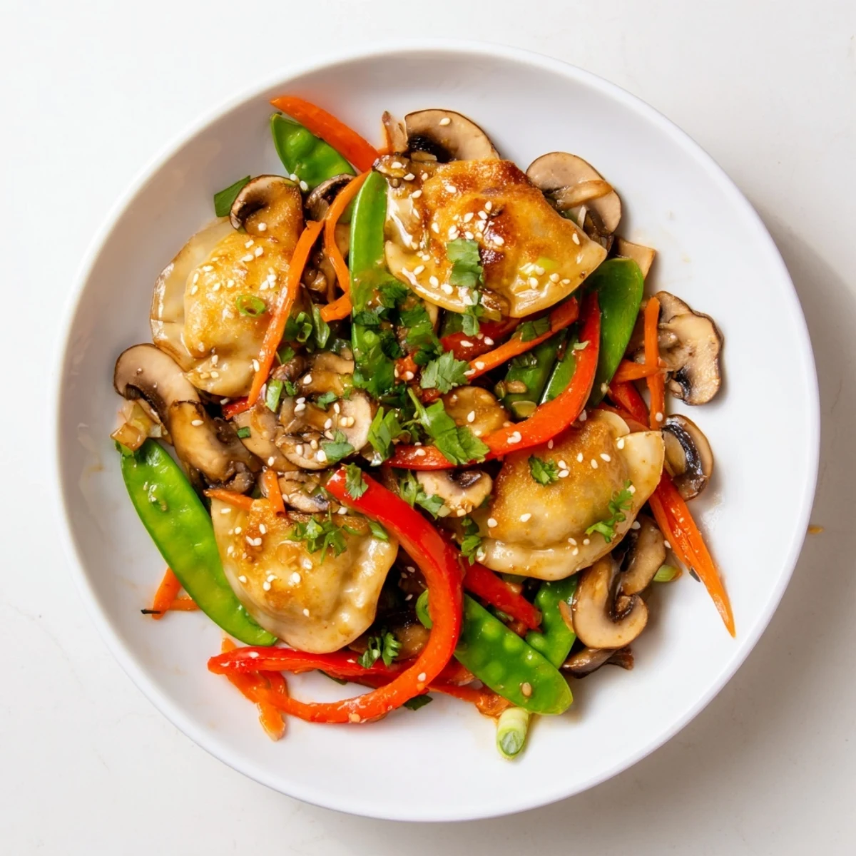 Vibrant Asian fusion bowl featuring pan-fried potstickers tossed with crisp snap peas and peppers