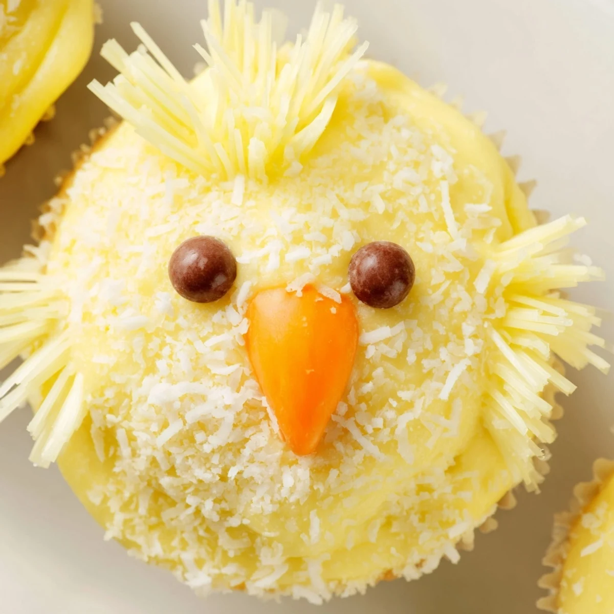 Homemade Easter Chick Cupcakes topped with fluffy buttercream and decorated with chocolate chip eyes