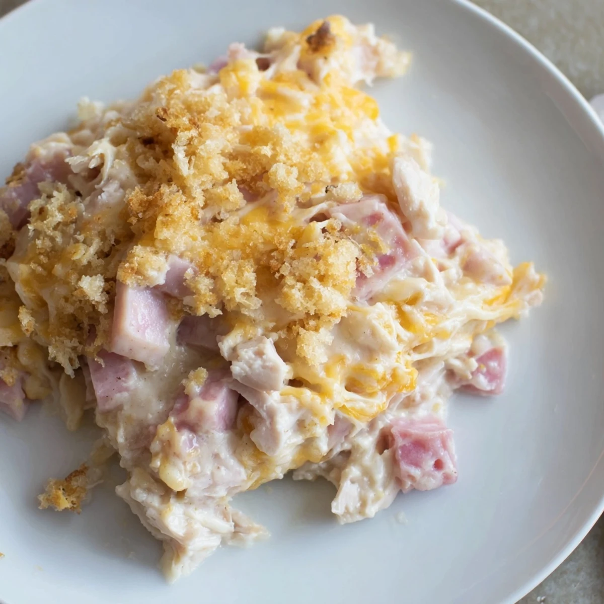 Golden, bubbling Chicken Cordon Bleu Casserole with melted Swiss and crispy Parmesan topping