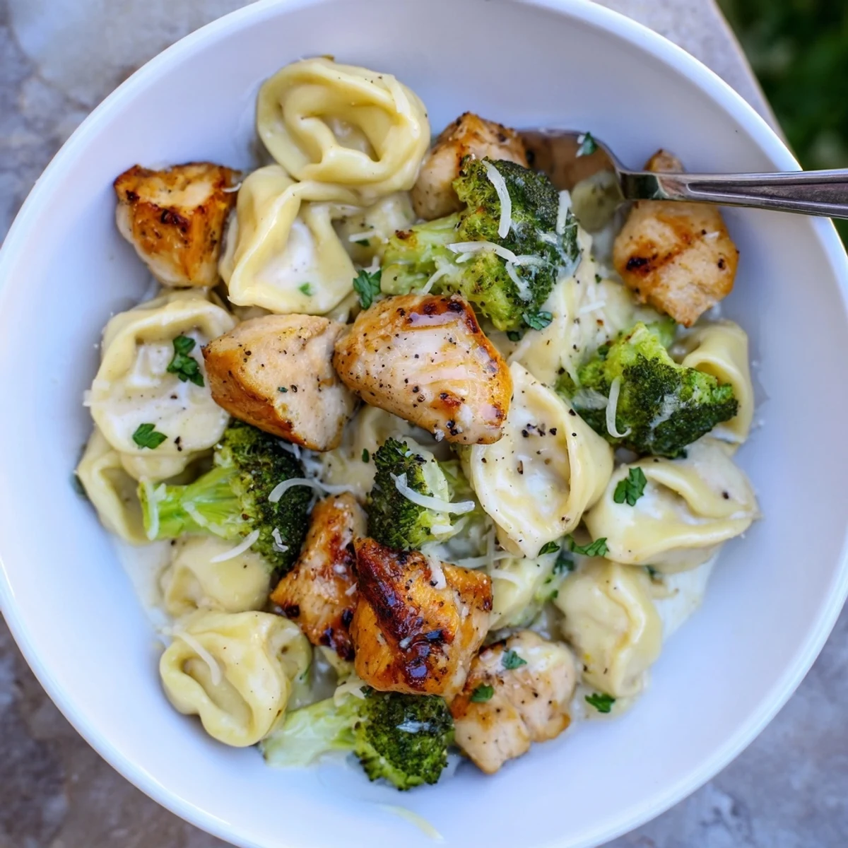Creamy Garlic Parmesan Tortellini Chicken Broccoli Recipe steaming, golden chicken, crisp green florets.