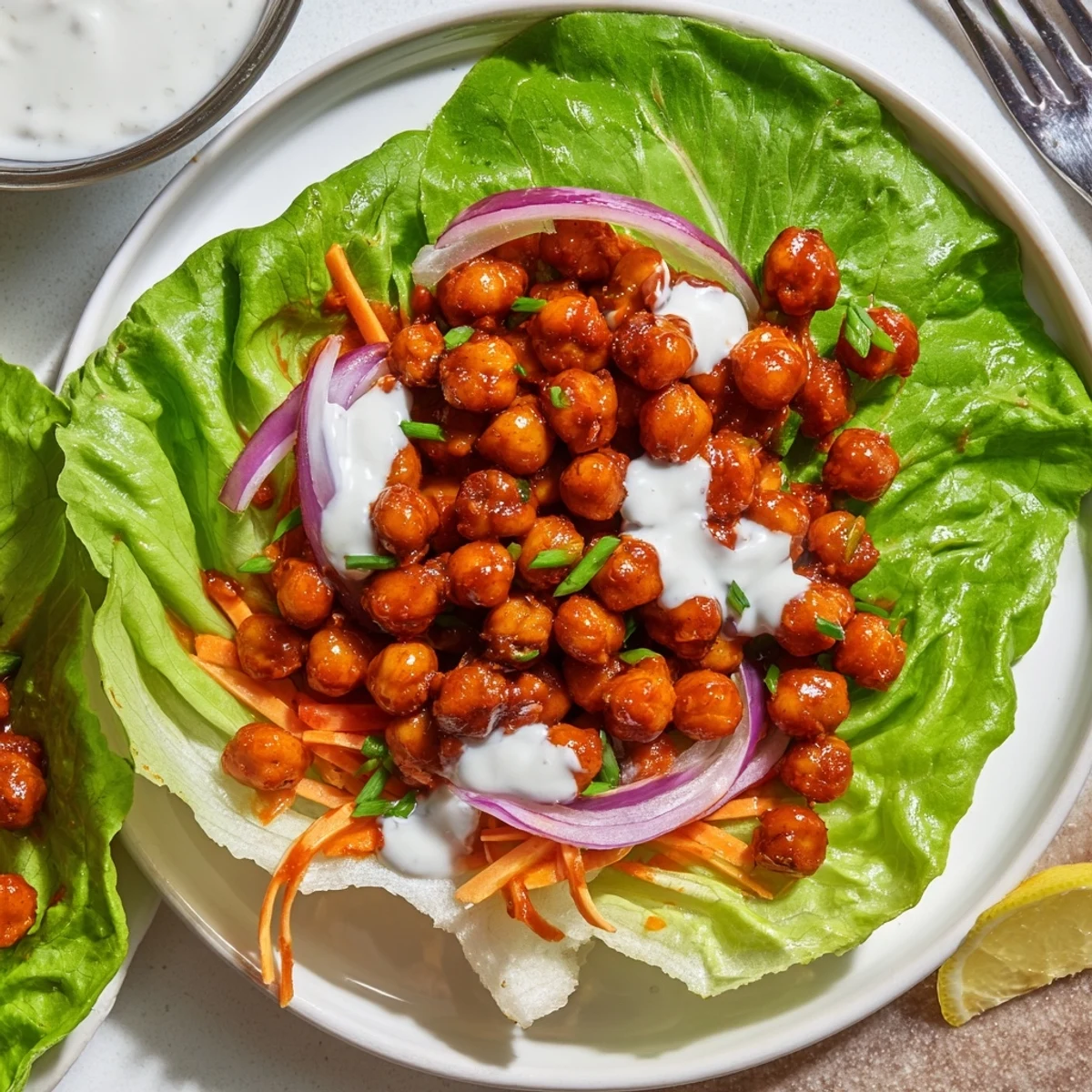 Bright Buffalo Chickpea Lettuce Wraps served with lemon wedge for tangy finish