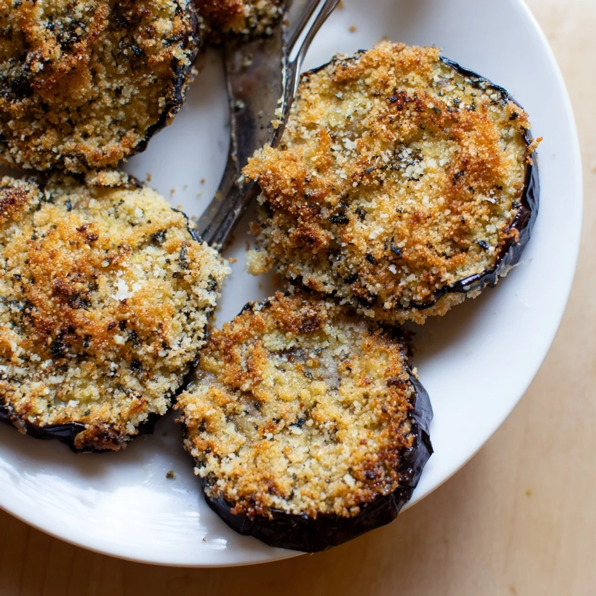 Oven-roasted Crispy Baked Eggplant on parchment, sizzling, tender inside.