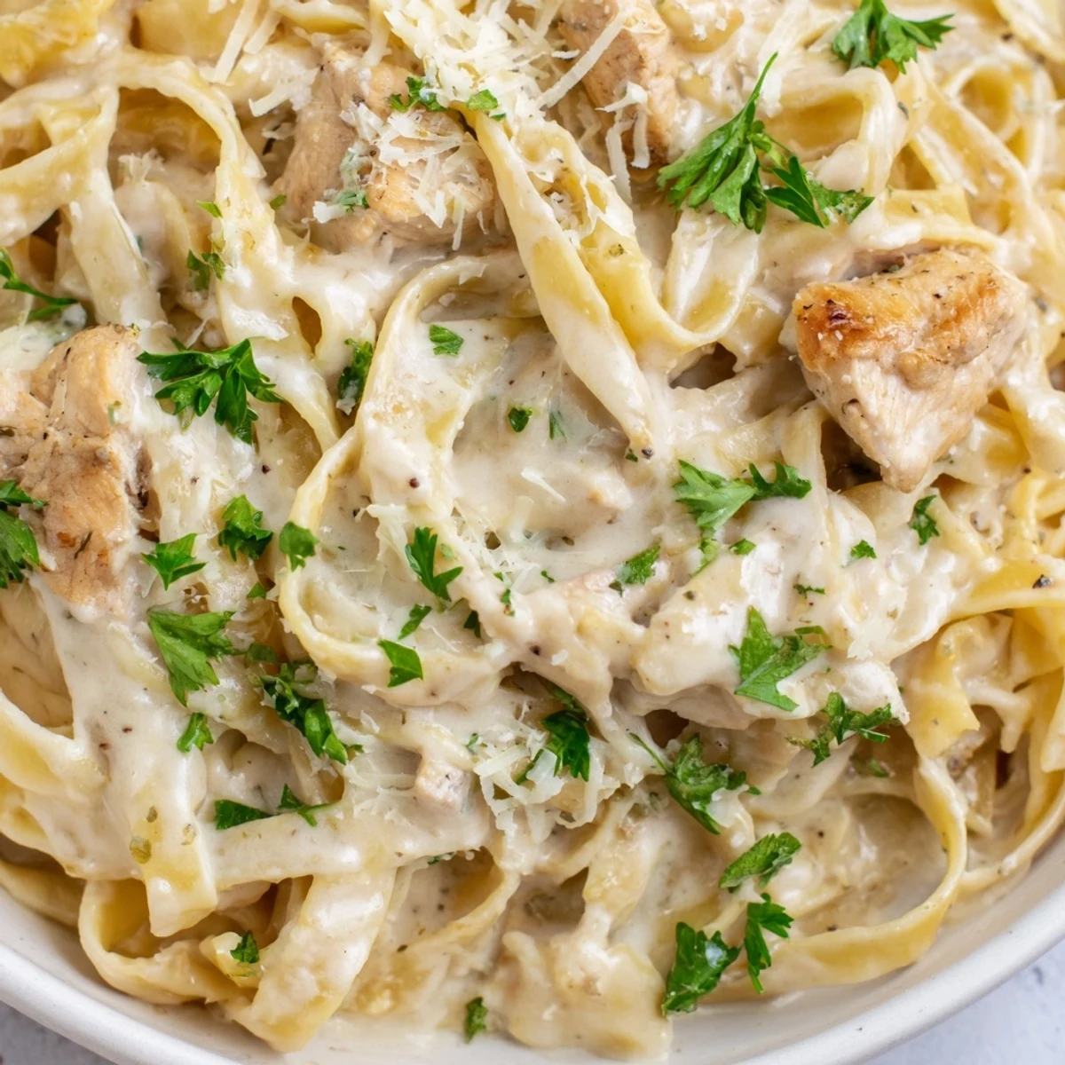 Creamy Garlic Parmesan Chicken Pasta plated with fresh parsley and extra cheese