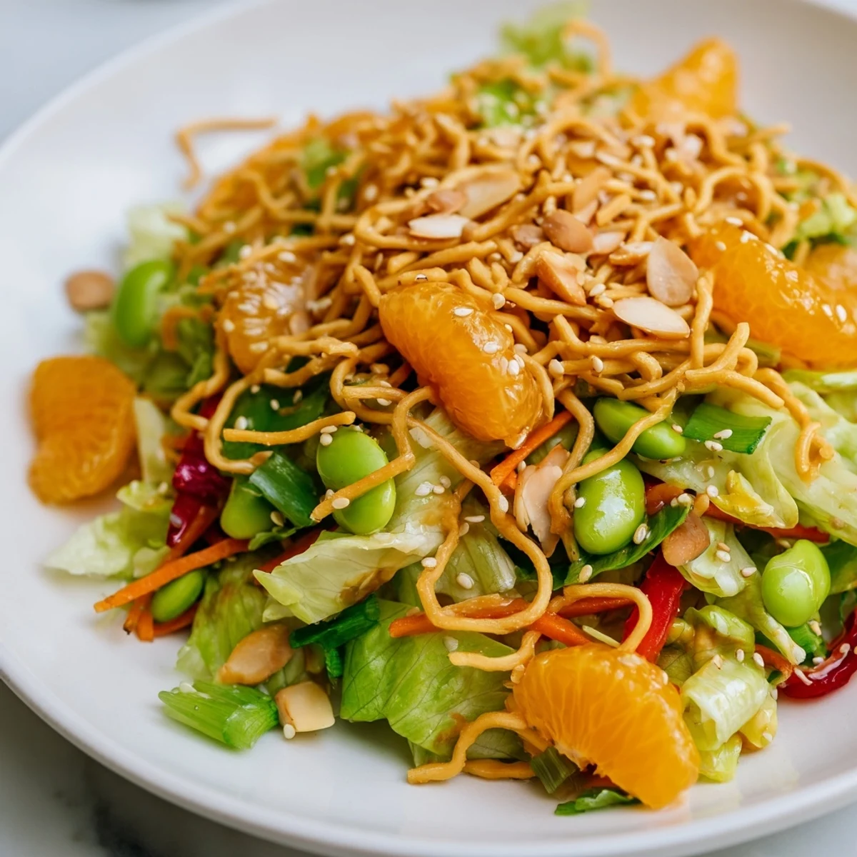 Crispy Mandarin Sesame Crunch Salad scattered with juicy orange segments and sesame seeds