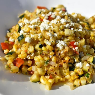 Colorful Mexican Calabacitas recipe featuring tender zucchini, sweet corn kernels, and crumbled queso fresco