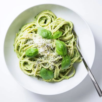 Al dente spaghetti tossed with rich avocado pesto featuring fresh spinach and aromatic basil